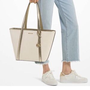 Brand new Michael Kors Cream and Gold Hobo Tote with MK Charm.